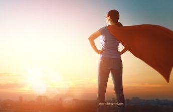 Image of midlife woman with red superwoman cape on looking powerful