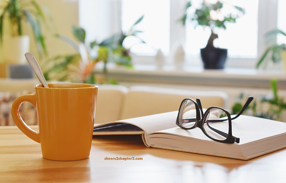 Image of tea cup, book and reading glasses - restful breaks increase productivity