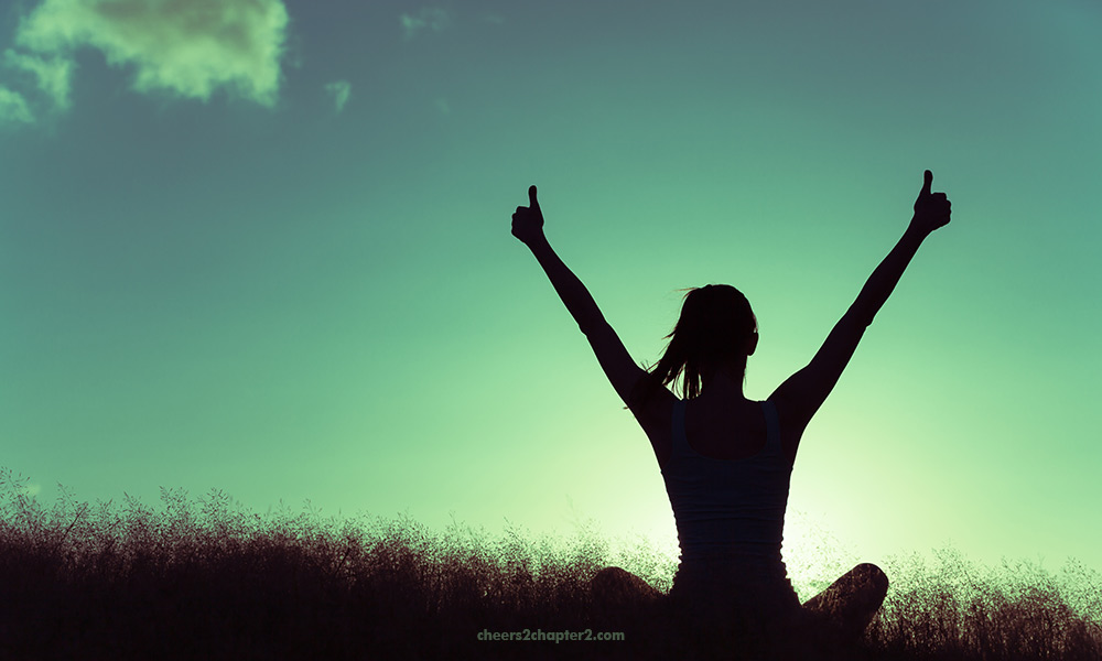 Image of woman with arms up in joy and victory for live your best life despite challenges