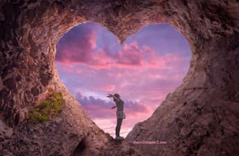letting go of self-consciousness Image of woman standing in a rock heart looking like she is feeling happy and free