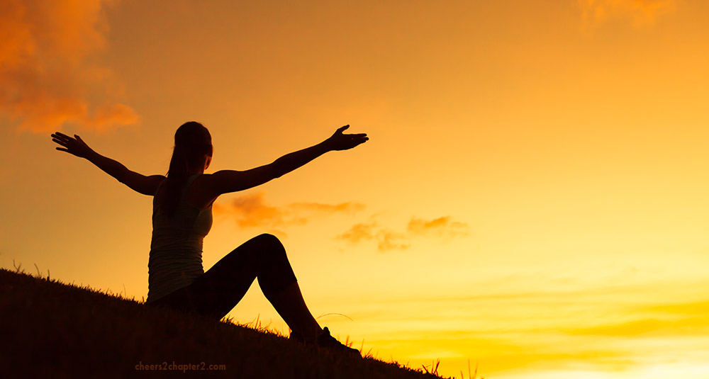 Woman on HIll with outstretched arms toward sun light for how do you know your purpose page