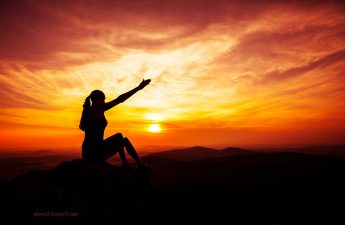 Woman on top of hill reaching arms up for How Do you Overcome Setbacks page